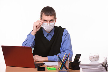 Image showing Clerk in a medical mask lowered his glasses from eye to nose