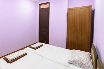 Image showing Budget bedroom interior with spacious bed and wardrobe