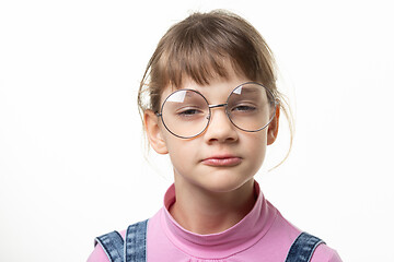 Image showing Portrait of a funny girl in glasses squinting eyes on a white background