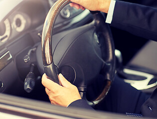 Image showing senior businessman hands driving car