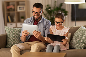 Image showing father and daughter with tablet computers at home