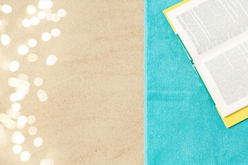 Image showing book on beach towel on sand