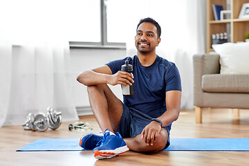 Image showing indian man drinking water after training at home