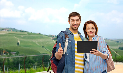 Image showing happy couple of tourists with tablet computer