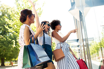 Image showing women with shopping bags looking at shop window