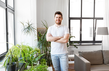 Image showing smiling man with houseplants at home