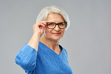 Image showing portrait of senior woman in glasses over grey