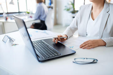 Image showing businesswoman with laptop working at office