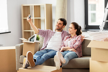 Image showing couple taking selfie by smartphone at new home