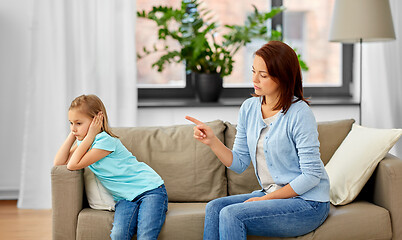 Image showing angry mother scolding her daughter at home