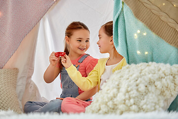 Image showing little girl playing tea party in kids tent at home