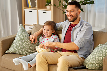 Image showing happy father and daughter watching tv at home