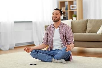 Image showing man in headphones meditating listening to music