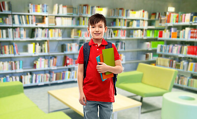 Image showing smiling student boy with books at library