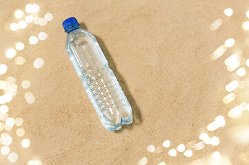 Image showing bottle of water on beach sand