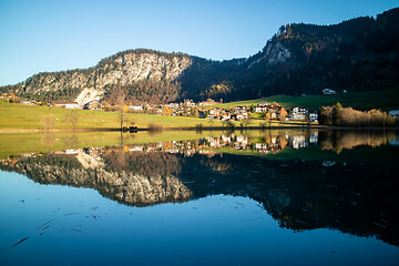 Image showing Beautiful landscape with country area near the lake and reflection in it.