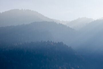 Image showing Mountain landscape with forest hills on a background of foggy sky, Kufstein Austria.