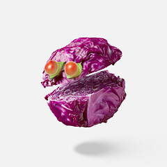 Image showing Cut red cabbage as a floating head with eyes from cherry tomatoes.