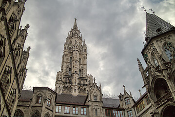 Image showing Old-fashioned architectural buildings against grey cloudy sky in Munich, Germany.