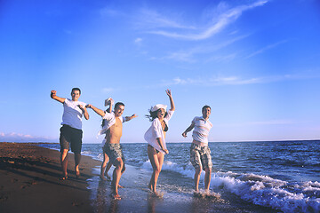 Image showing people group running on the beach