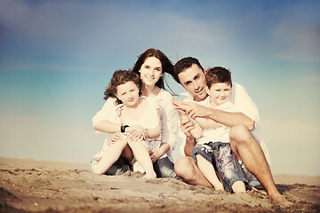 Image showing happy young family have fun on beach