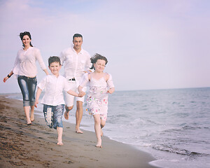 Image showing happy young family have fun on beach