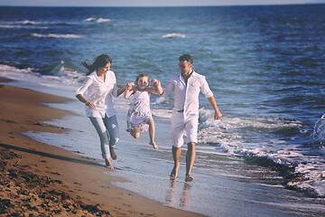 Image showing happy young  family have fun on beach