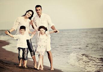 Image showing happy young family have fun on beach