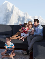 Image showing happy young couple spending time with kids at home