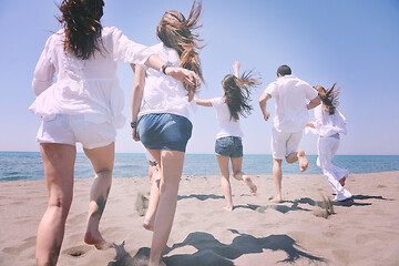 Image showing happy people group have fun and running on beach