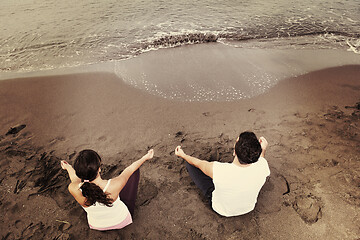 Image showing couple yoga beach