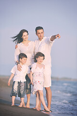 Image showing happy young family have fun on beach at sunset