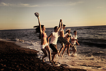 Image showing people group running on the beach