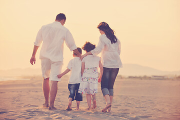 Image showing happy young family have fun on beach at sunset