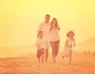 Image showing happy young family have fun on beach at sunset