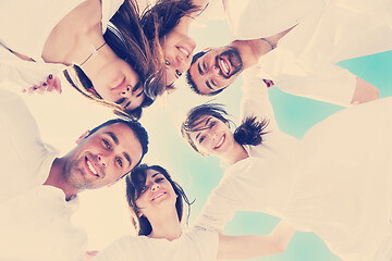 Image showing Group of happy young people in circle at beach