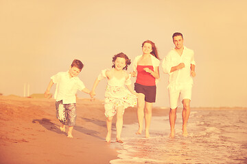 Image showing happy young family have fun on beach