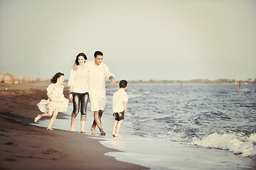 Image showing happy young family have fun on beach at sunset