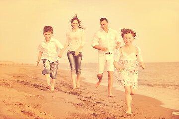 Image showing happy young family have fun on beach