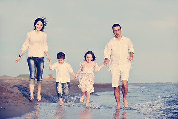 Image showing happy young family have fun on beach