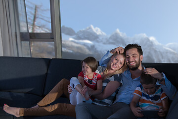 Image showing happy young couple spending time with kids at home