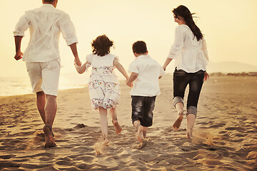 Image showing happy young family have fun on beach at sunset