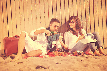 Image showing young couple enjoying  picnic on the beach