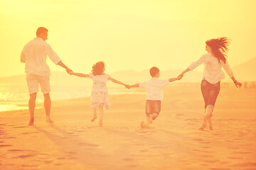 Image showing happy young family have fun on beach at sunset