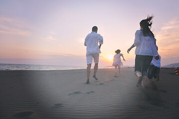 Image showing happy young family have fun on beach at sunset