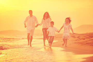 Image showing happy young family have fun on beach at sunset