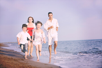 Image showing happy young family have fun on beach