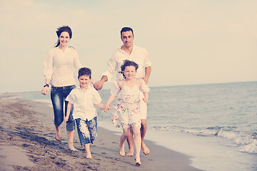 Image showing happy young family have fun on beach