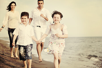 Image showing happy young family have fun on beach