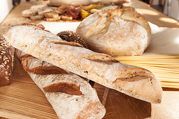 Image showing Gluten free food. Various pasta, bread and snacks on wooden background from top view